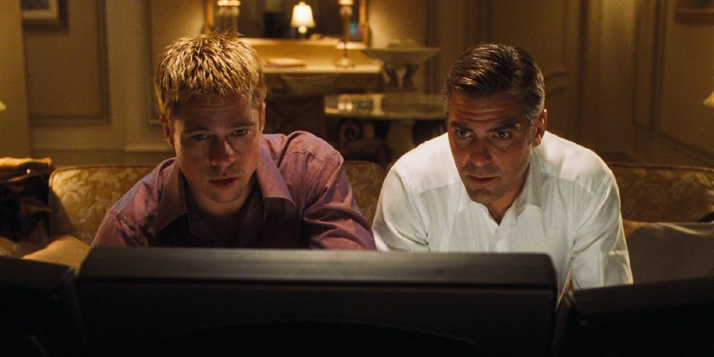 Brad Pitt and George Clooney looking at a computer in Ocean's Eleven