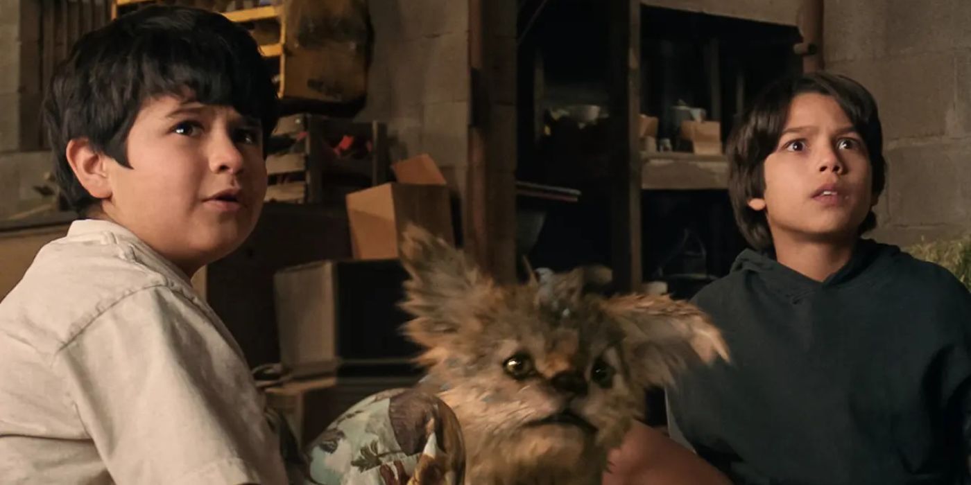 Nickolas Verdugo as Memo sitting next to a baby Chupacabra and Alex in Chupa.