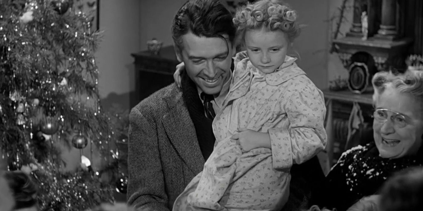 George (James Stewart) holding his daughter and happy to see his friends come to support him. 