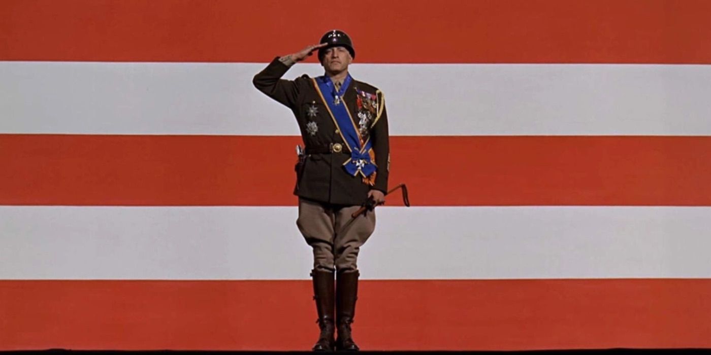 General Patton in full military regalia saluting in front of a huge American flag. (Patton)