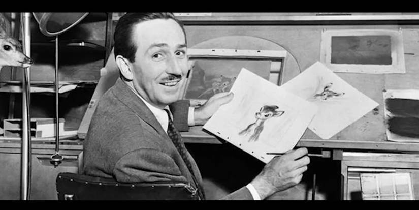 Walt Disney smiling as he holds a sketched image of Bambi