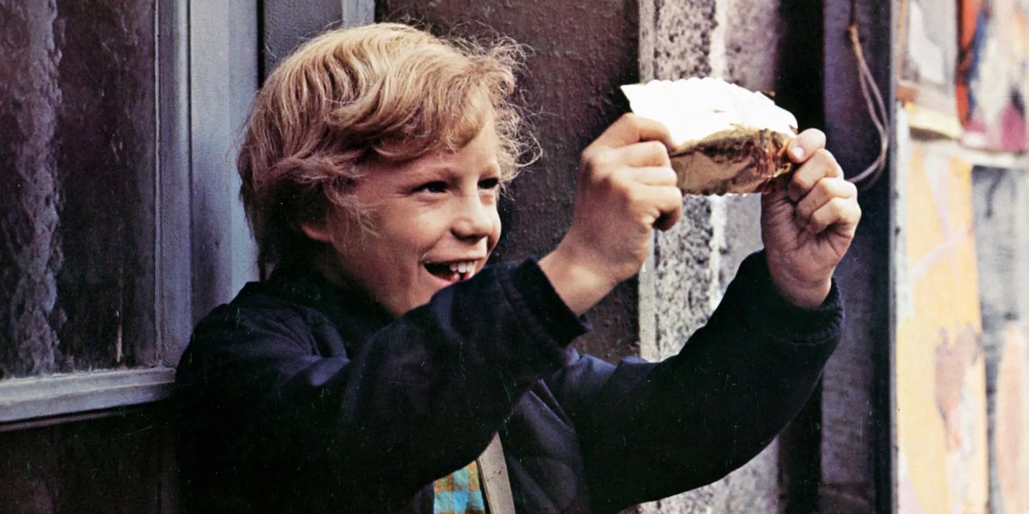Peter Ostrum as Charlie Bucket holding up a Golden Ticket in Willy Wonka & The Chocolate Factory