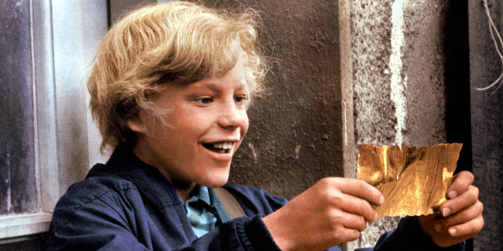 Peter Ostrum as Charlie gazing at a Golden Ticket in awe in Willy Wonka & The Chocolate Factory