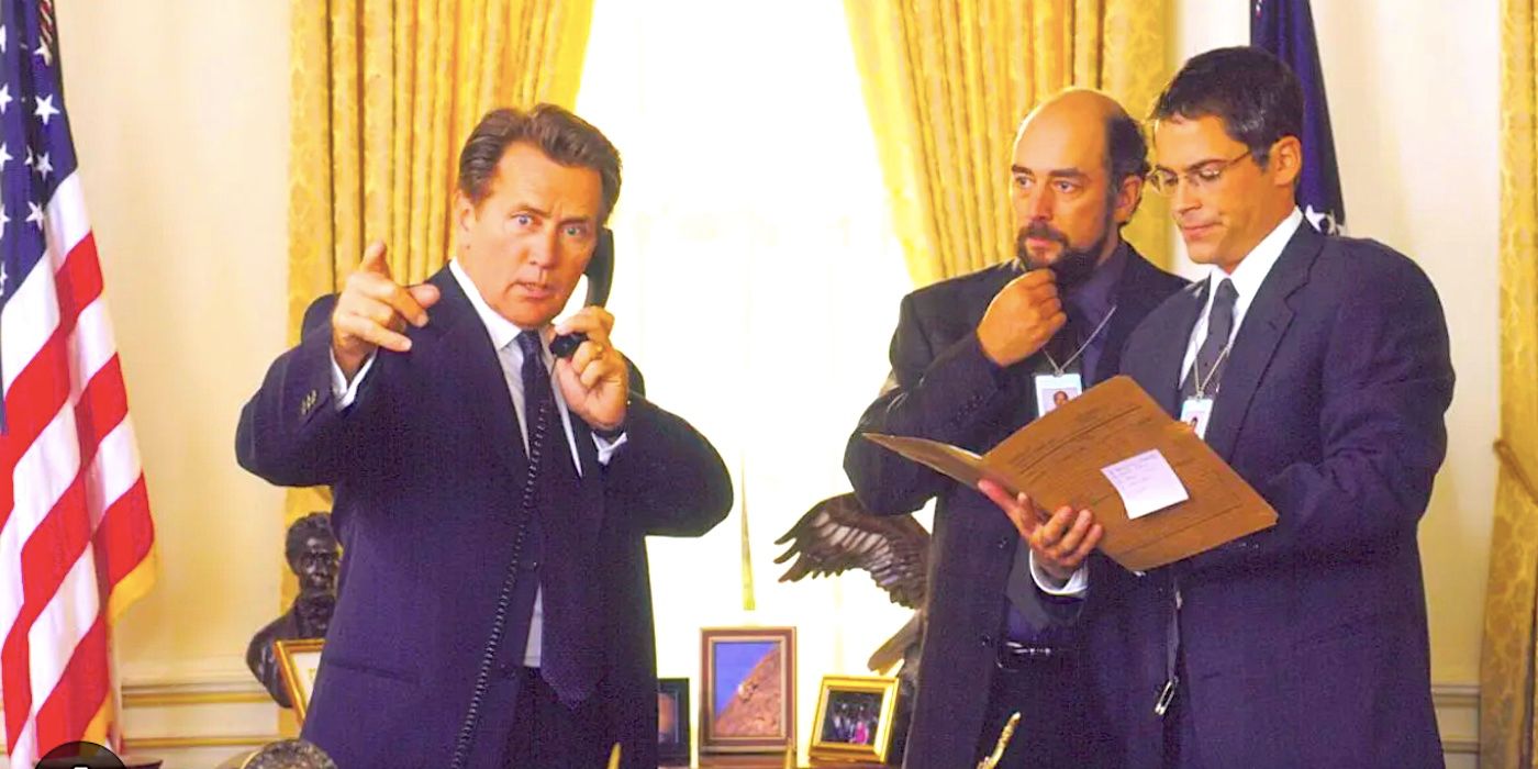 President Bartlet takes a phone call as Sam and Toby look on in the Oval Office in The West Wing