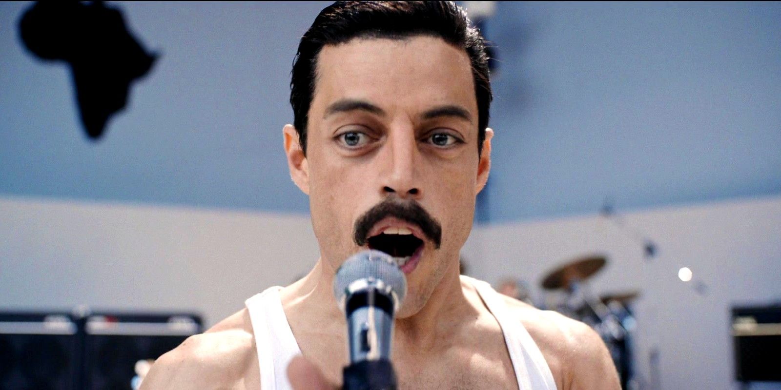 Rami Malek as Freddie Mercury singing at Live Aid in Bohemian Rhapsody