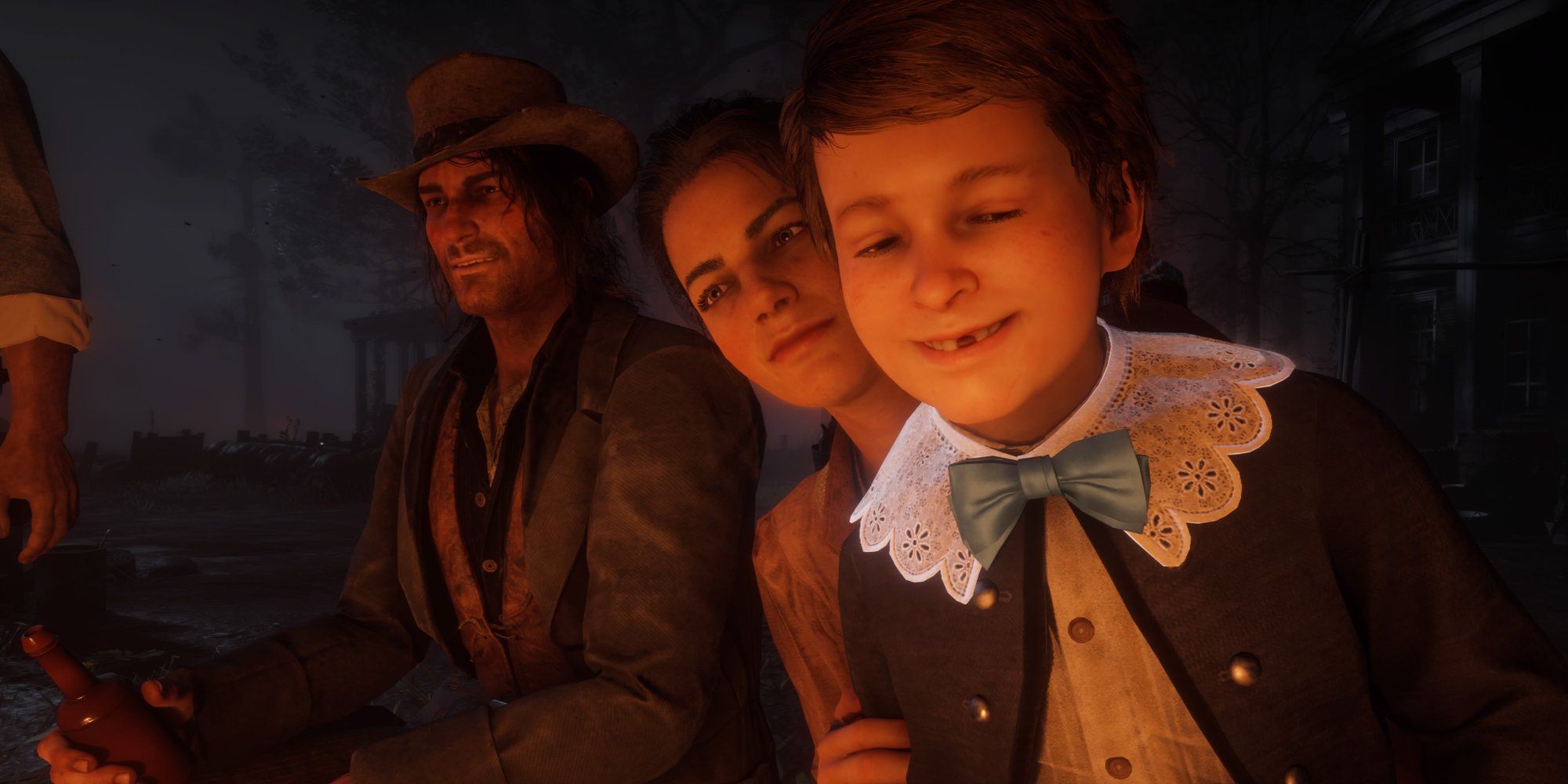 The Marston Family sit at a campfire in Red Dead Redemption 2