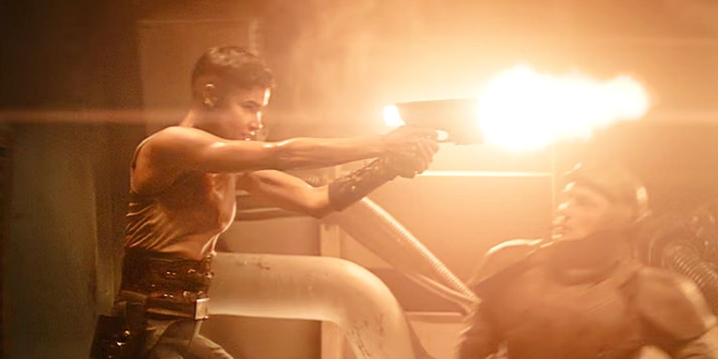 Sofia Boutella as Kora shooting a blaster over an Imperium soldier's head in Rebel Moon 2.