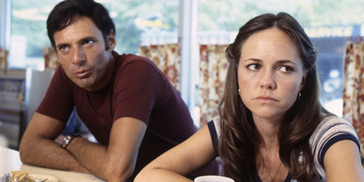 Reuben and Nora sitting a diner with their arms cross in Norma Rae - Sally Field as Norma Rae Webster - Norma Rae (1979)
