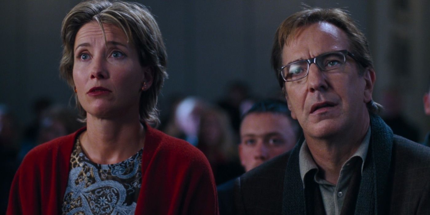 Emma Thompson and Alan Rickman sit in an auditorium watching their kids' play in Love Actually.