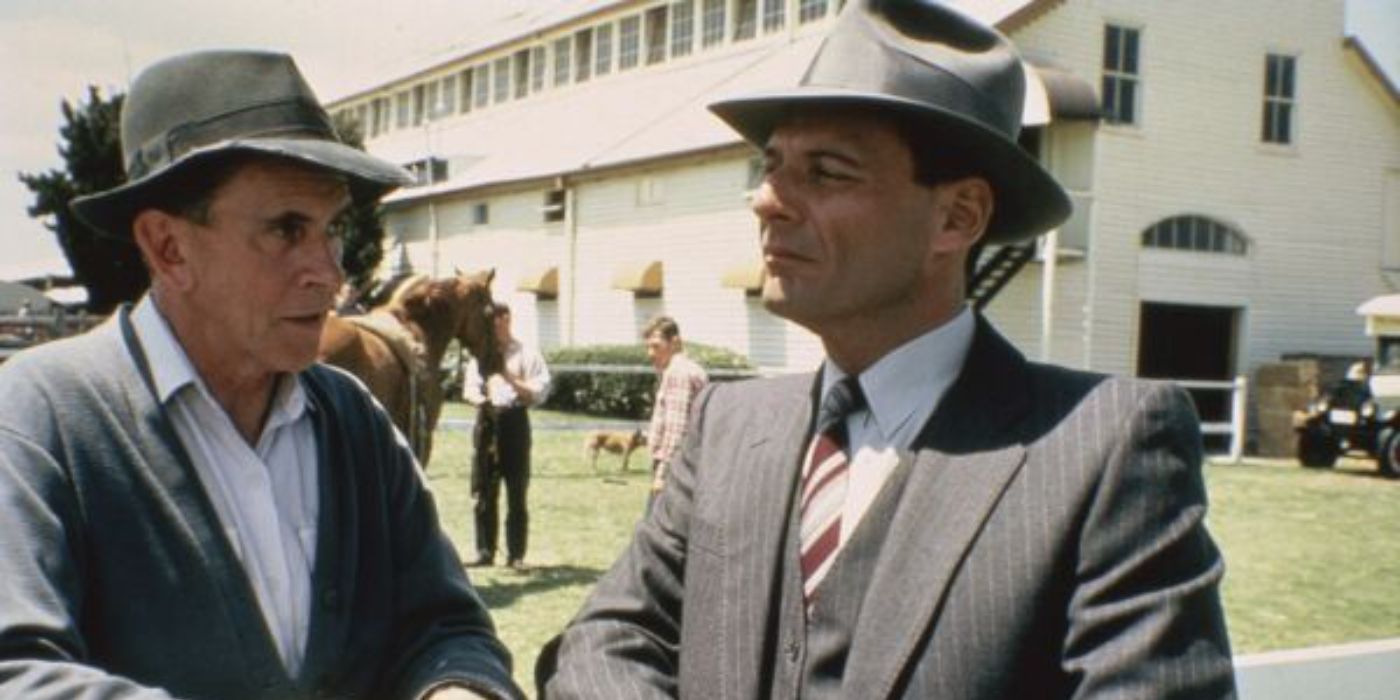Ron Leibman as Dave Davis, making eye contact with another man in Phar Lap.