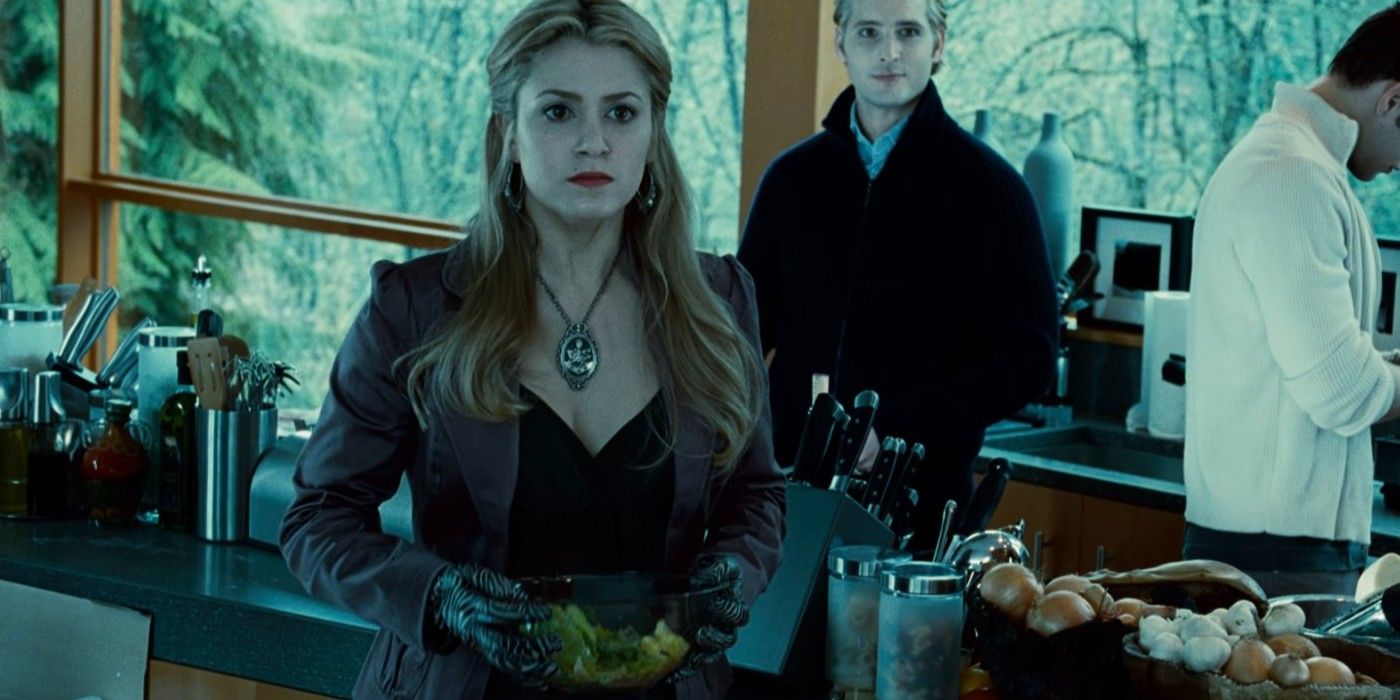 rosalie (Nikki Reed) looks concerned in the kitchen with Carlisle behind her in twilight