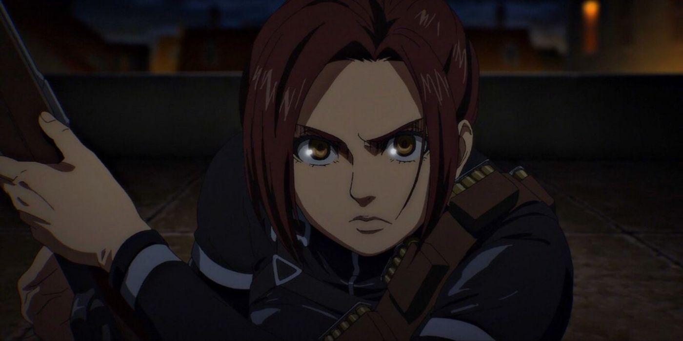 Sasha holds a weapon with a determined expression in Attack on Titan
