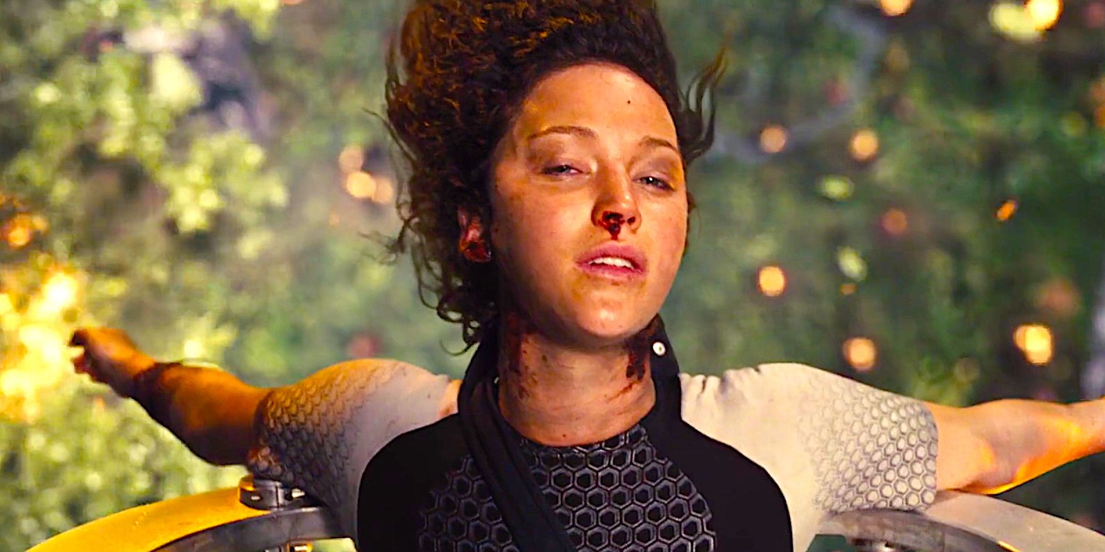 Katniss bloodied and bruised getting picked up by a massive claw in The Hunger Games Catching Fire