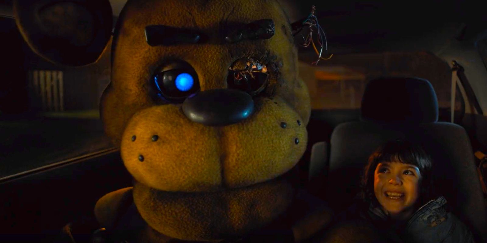 Golden Freddy sitting next to a smiling Abby in Five Nights at Freddy's movie