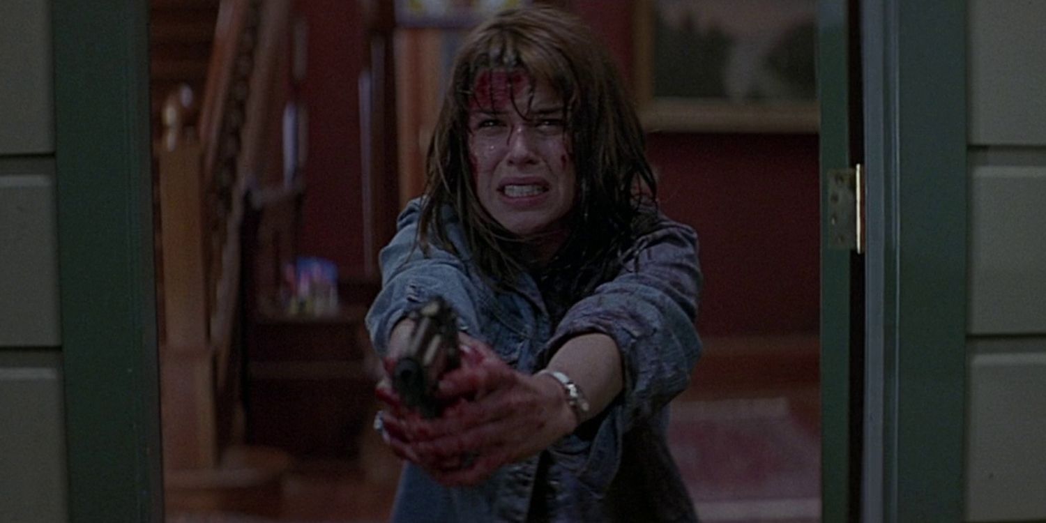 Neve Campbell's Sidney Prescott holds a gun in Scream