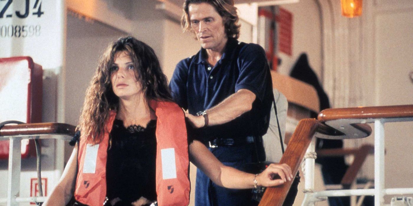 Sandra Bullock's Annie Porter wears a life jacket and is held hostage and pushed by Willem Dafoe's John Geiger in Speed 2: Cruise Control.