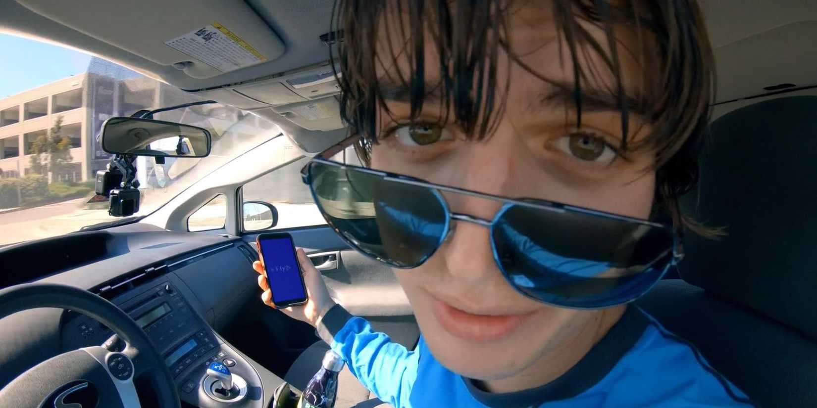 an intense close-up of Joe Keery in the driver's seat of a car in Spree