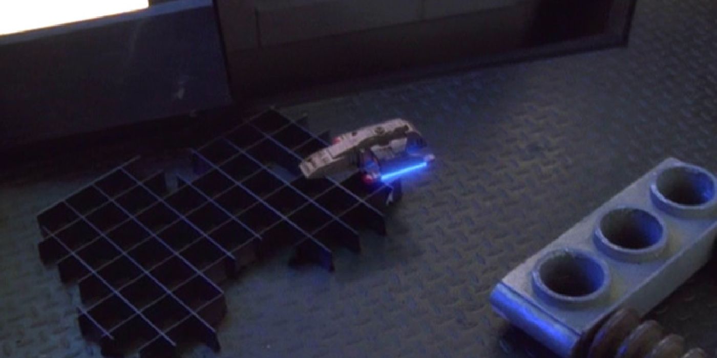 The shrunken Runabout flies around the USS Defiant