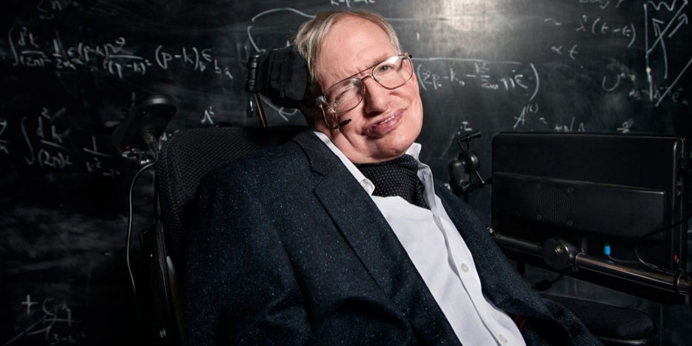 Stephen Hawking in front of a blackboard with equations written on it
