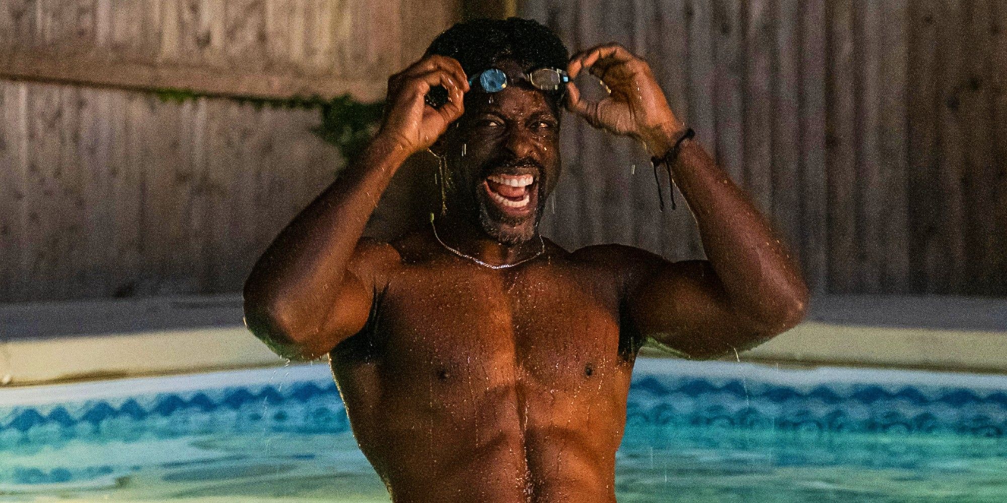 Sterling K Brown in a pool pushing his goggles up on his forehead, looking like he's in the middle of yelling, in American Fiction