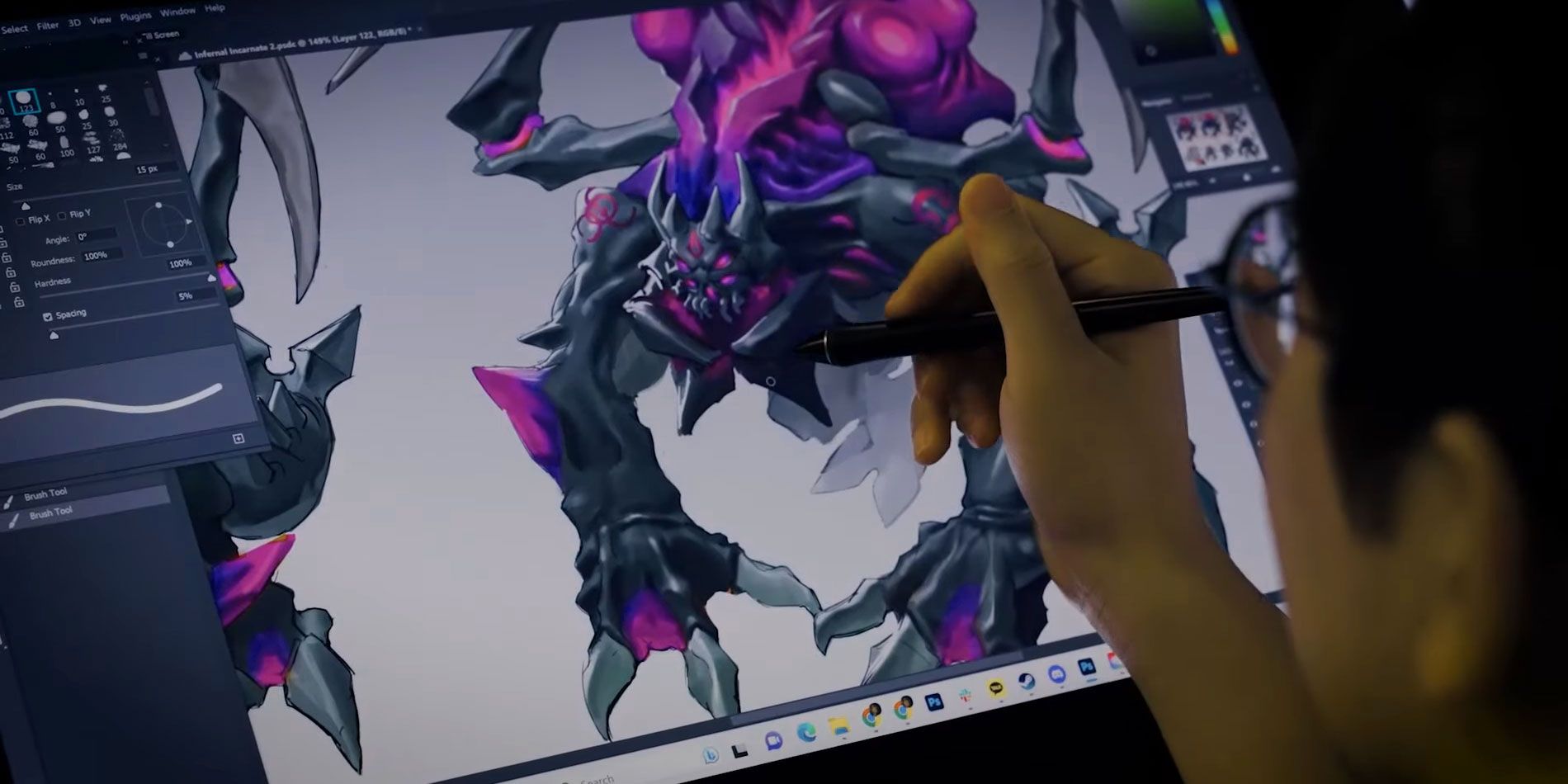 Stormgate creature artist editing an image on his computer.