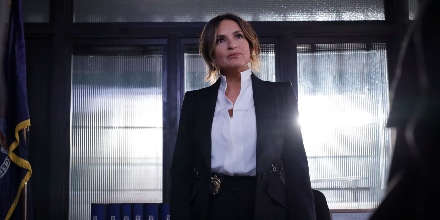 Olivia Benson standing at her desk with light coming in behind her in the episode Gimme Shelter