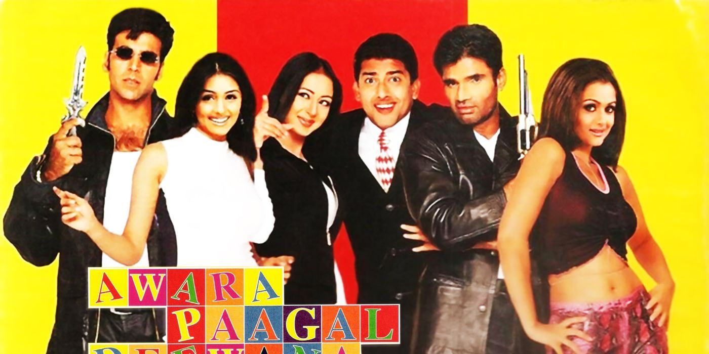 The cast of Awara Paagal Deewana posing and smiling while some hold up guns with the title of the film in front of them.-1