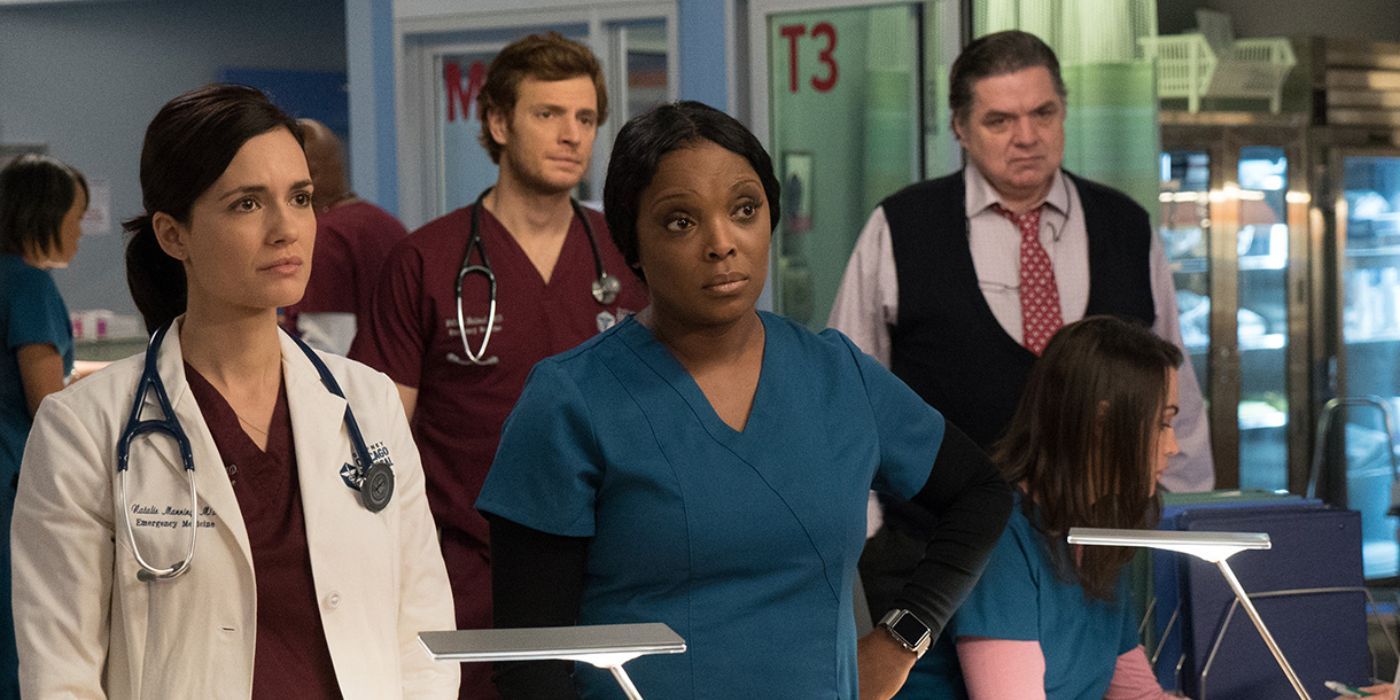 Natalie, Will, Maggie and Daniel looking at something in Chicago Med