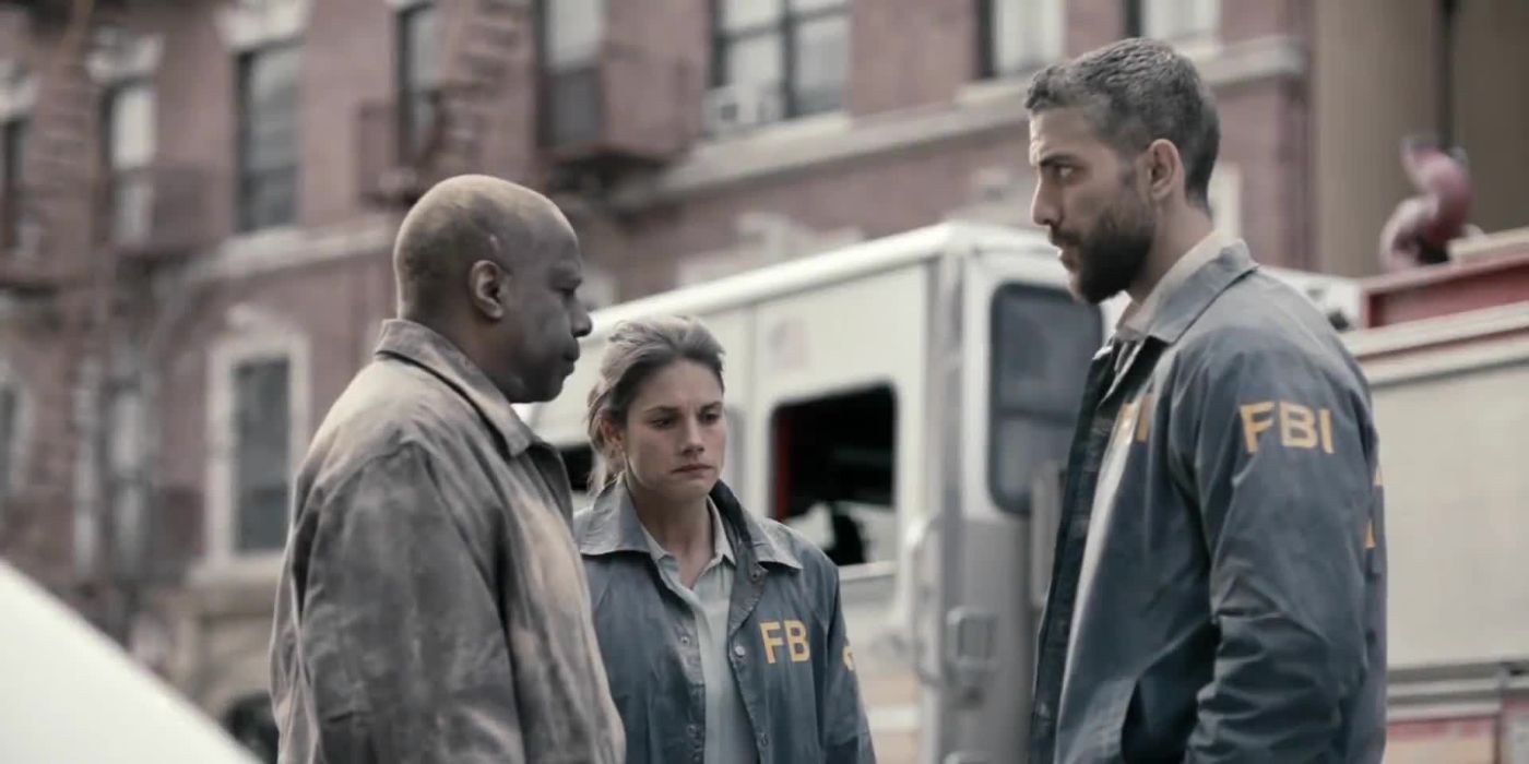 Omar and Maggie talking to a detective while covered in dust in FBI