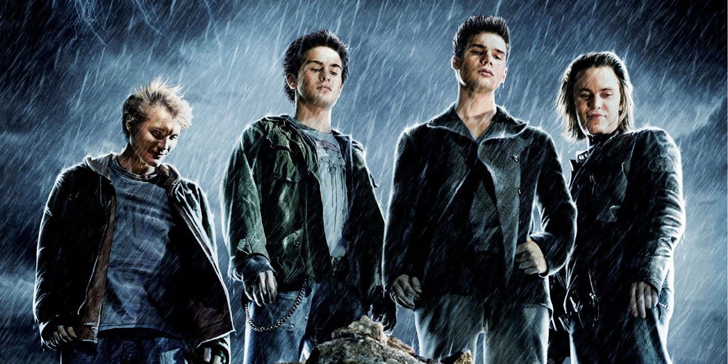 The Covenant - Main characters looking down and standing in the rain
