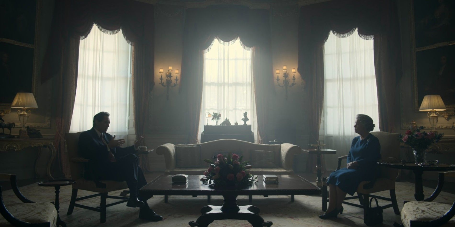 Tony Blair and Queen Elizabeth II sit across the room speaking in The Crown season 6
