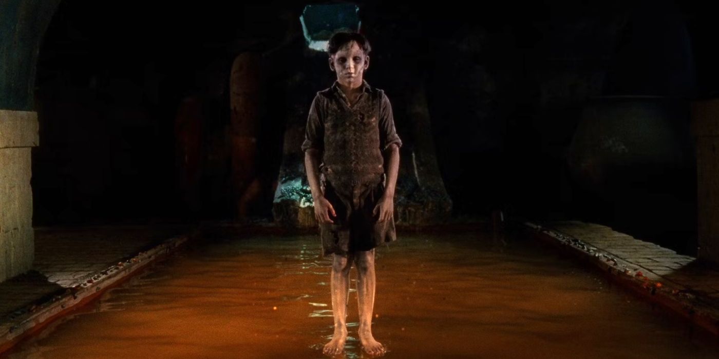 Still from The Devil's Backbone (2001) a ghost stands upon the surface of the water, centre frame 