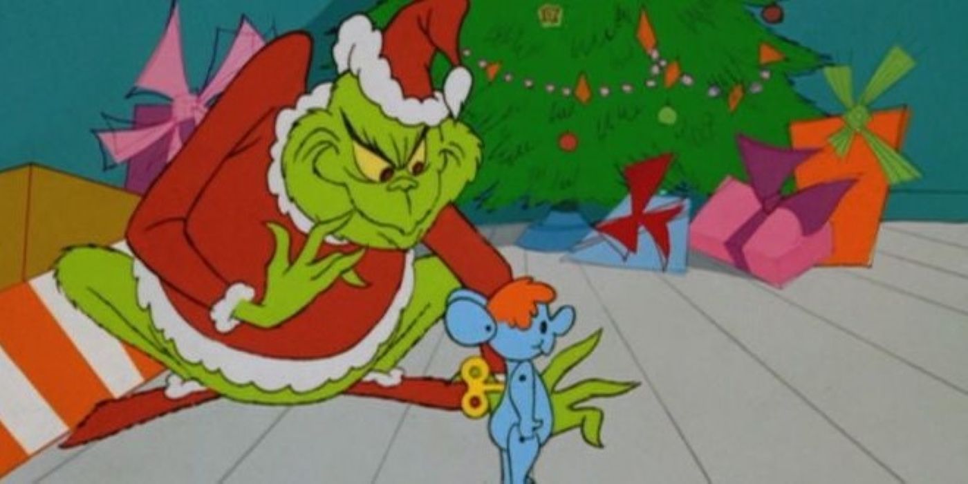 O Grinch roubando um brinquedo debaixo de uma árvore de Natal em How the Grinch Stole Christmas