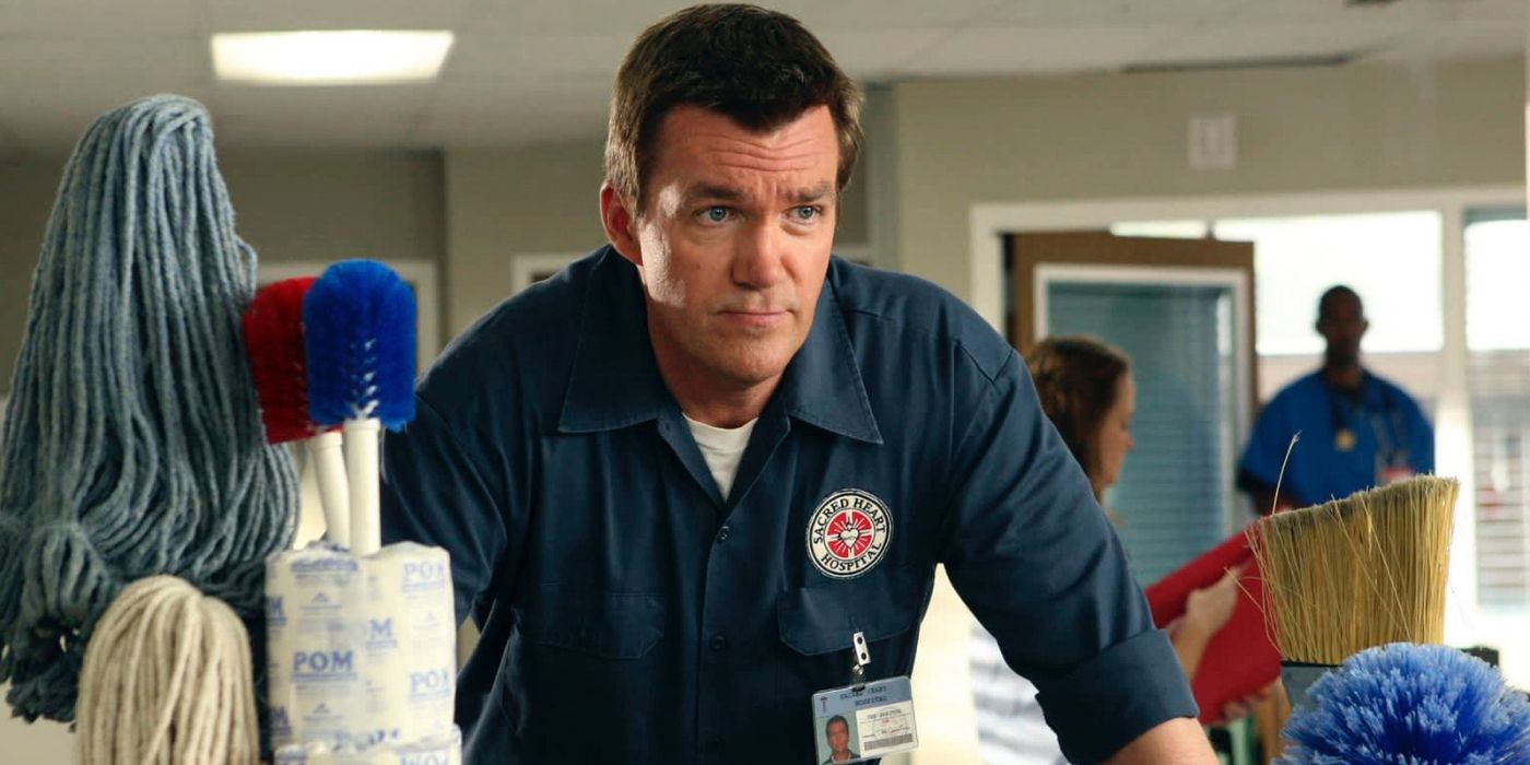 Neil Flynn as The Janitor pushing around cleaning supplies in Scrubs.