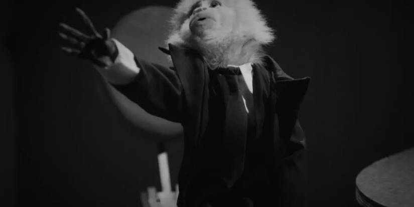 The monkey in a tuxedo with his arm oustretched in What Did Jack Do