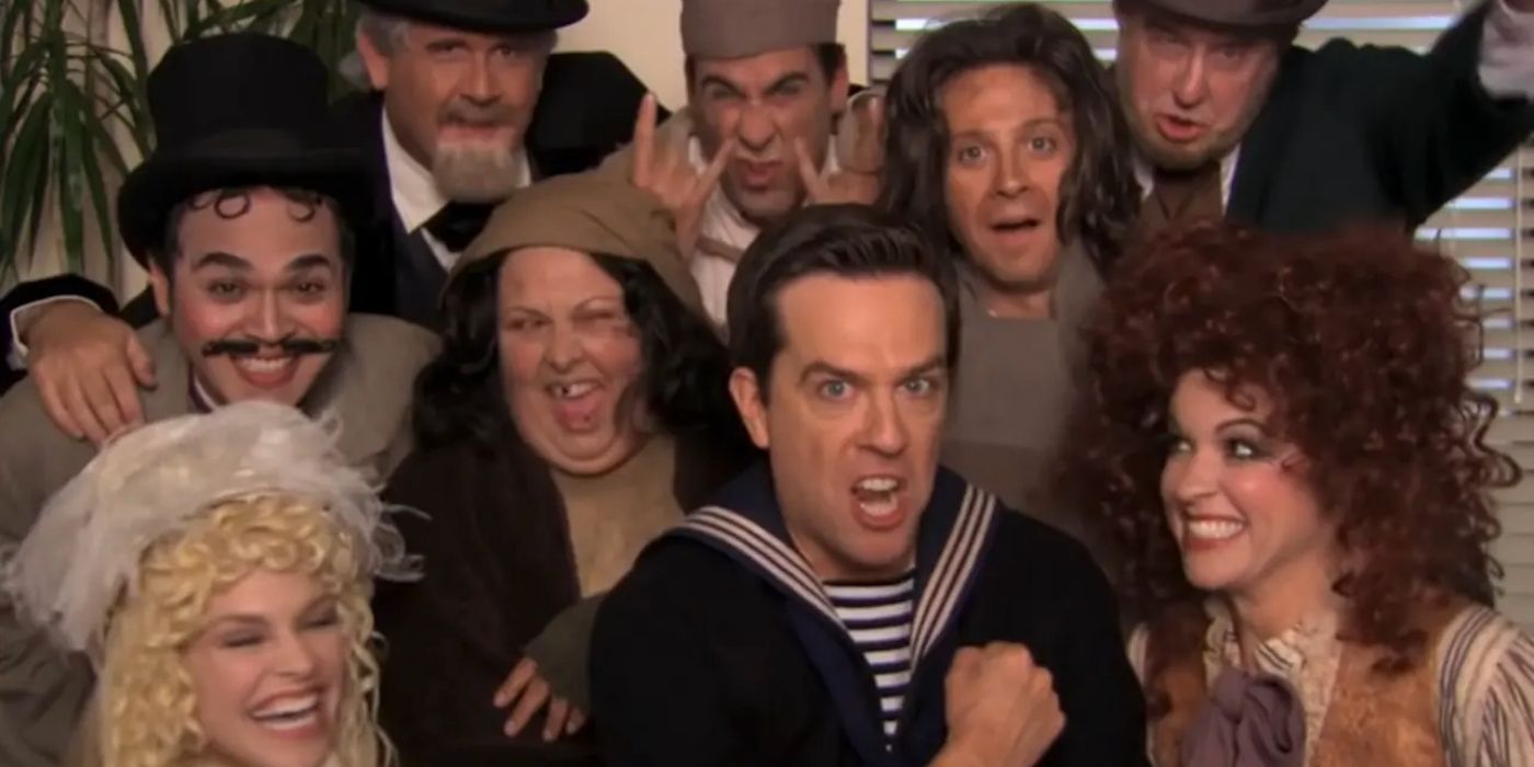 Andy and the cast of his play huddled together in front of the camera in The Office