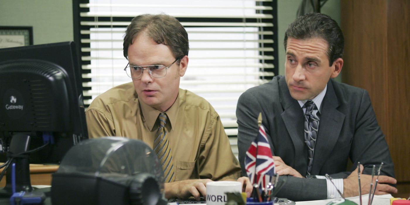 Rainn Wilson and Steve Carell as Dwight Schrute and Michael Scott looking at a computer screen in The Office