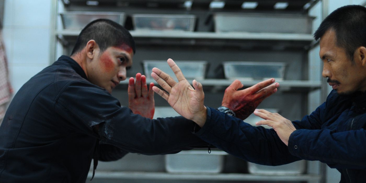 Rama and The Assassin gauge each other's range with bloody hands inside an empty kitchen in The Raid 2's climactic fight scene