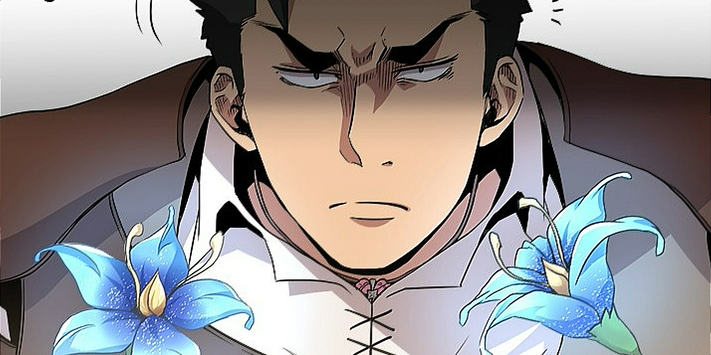 A man looks ahead with two blue flowers on either side.
