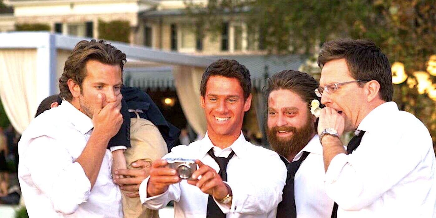 The Wolf Pack look at photos on a digital camera in the ending of The Hangover