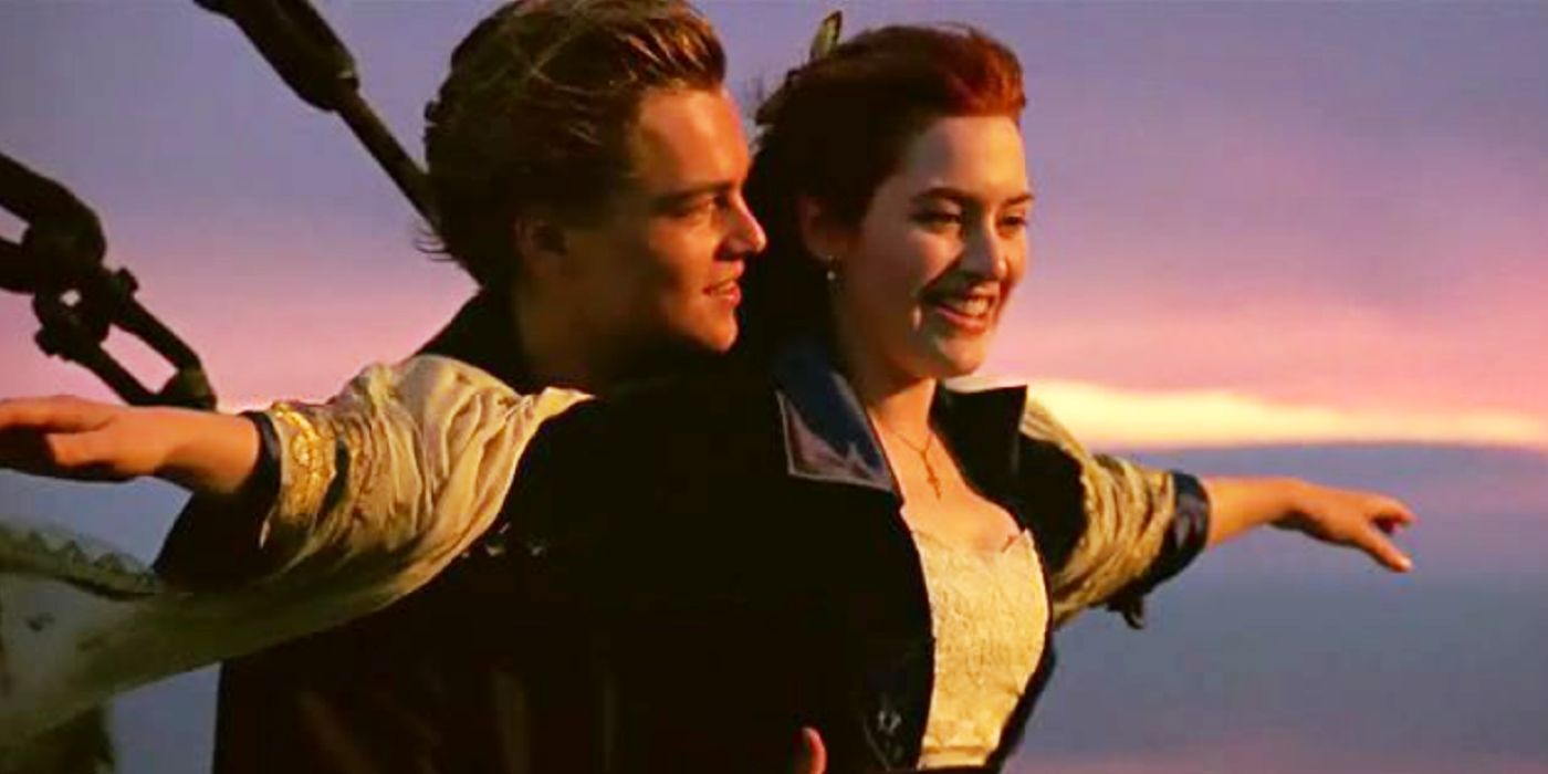 Jack holding Rose from behind as she holds her arms out wide in Titanic.
