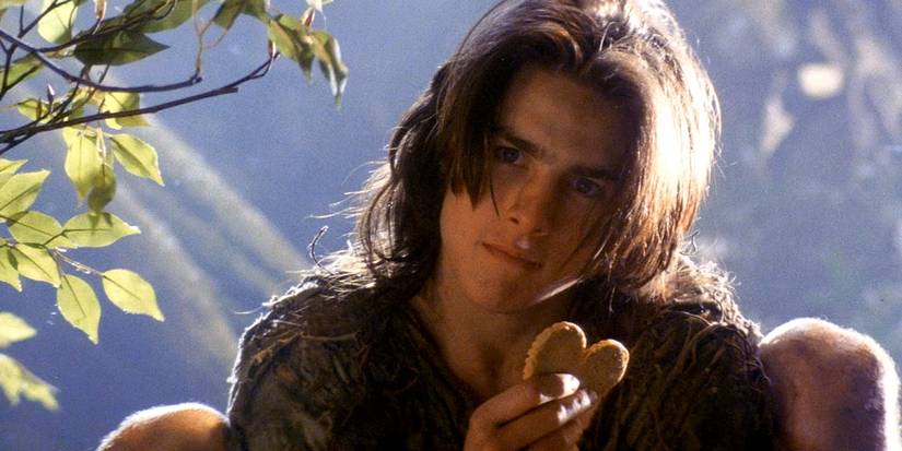 Tom Cruise as Jack holding a cookie in Legend.