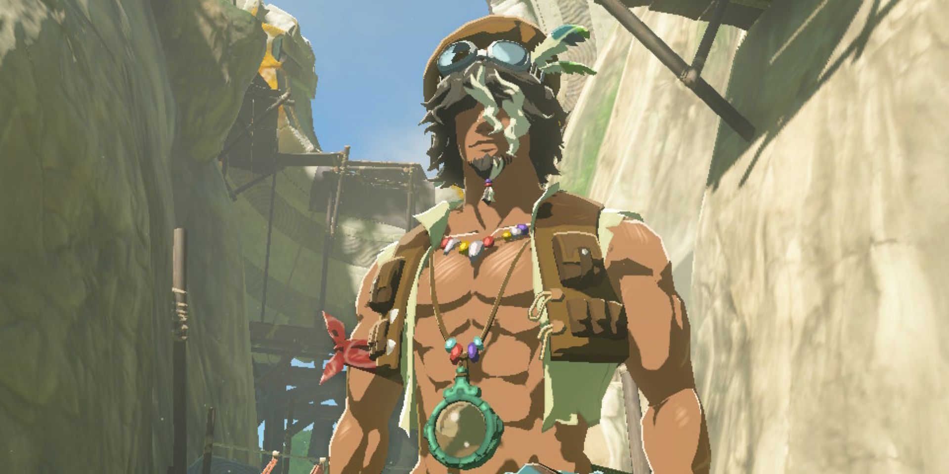 Tauro, the researcher in a floppy hat and open vest, stands beneath the Kakariko Village Ring Ruins in a screenshot from Zelda: Tears of the Kingdom.