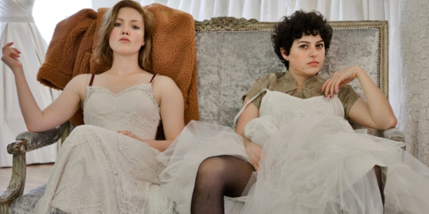 Two young women appear angry sitting in wedding dresses in Animals