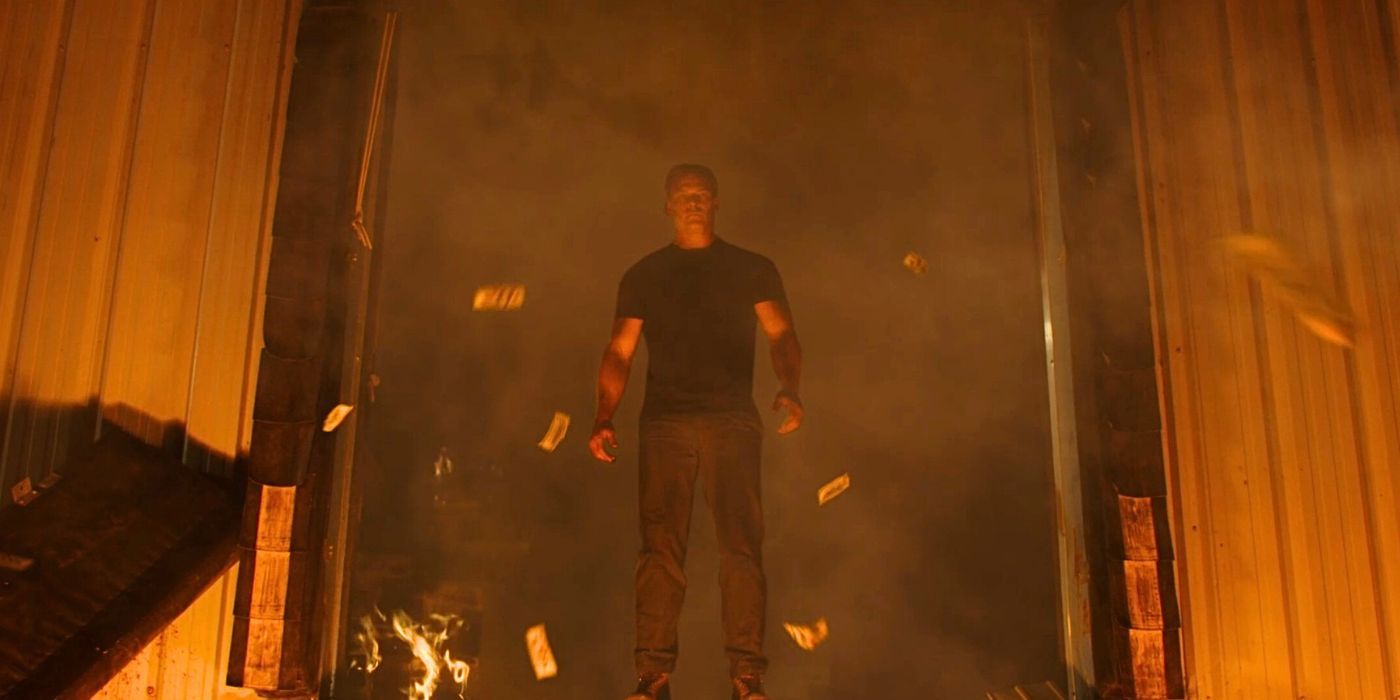 Jack Reacher walks out of a burning building in Reacher season 1's finale