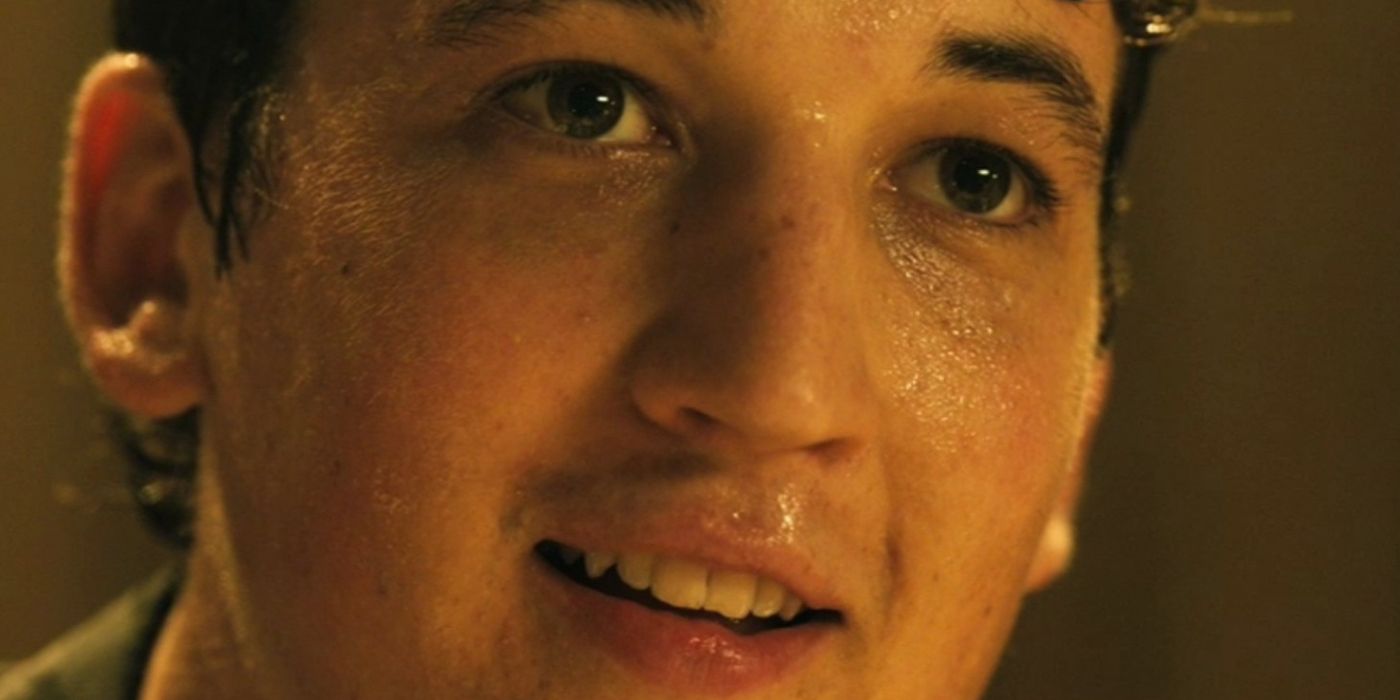 Miles Teller as Andrew smiles while covered in sweat in the final scenes of Whiplash.