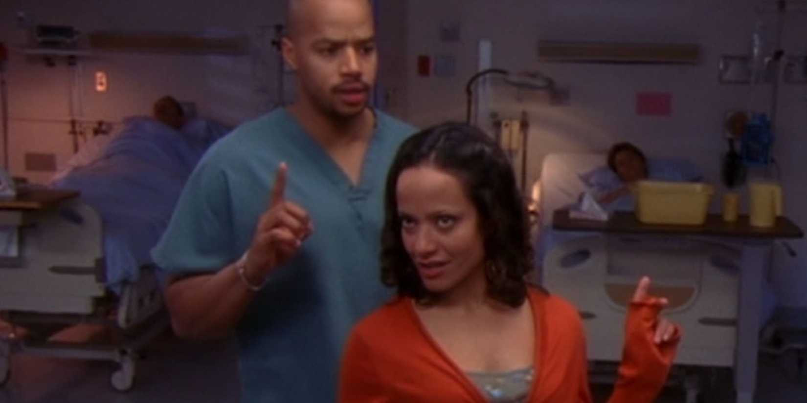 Judy Reyes as Carla in Scrubs with her back to Donald Faison as Turk who has one finger in the air
