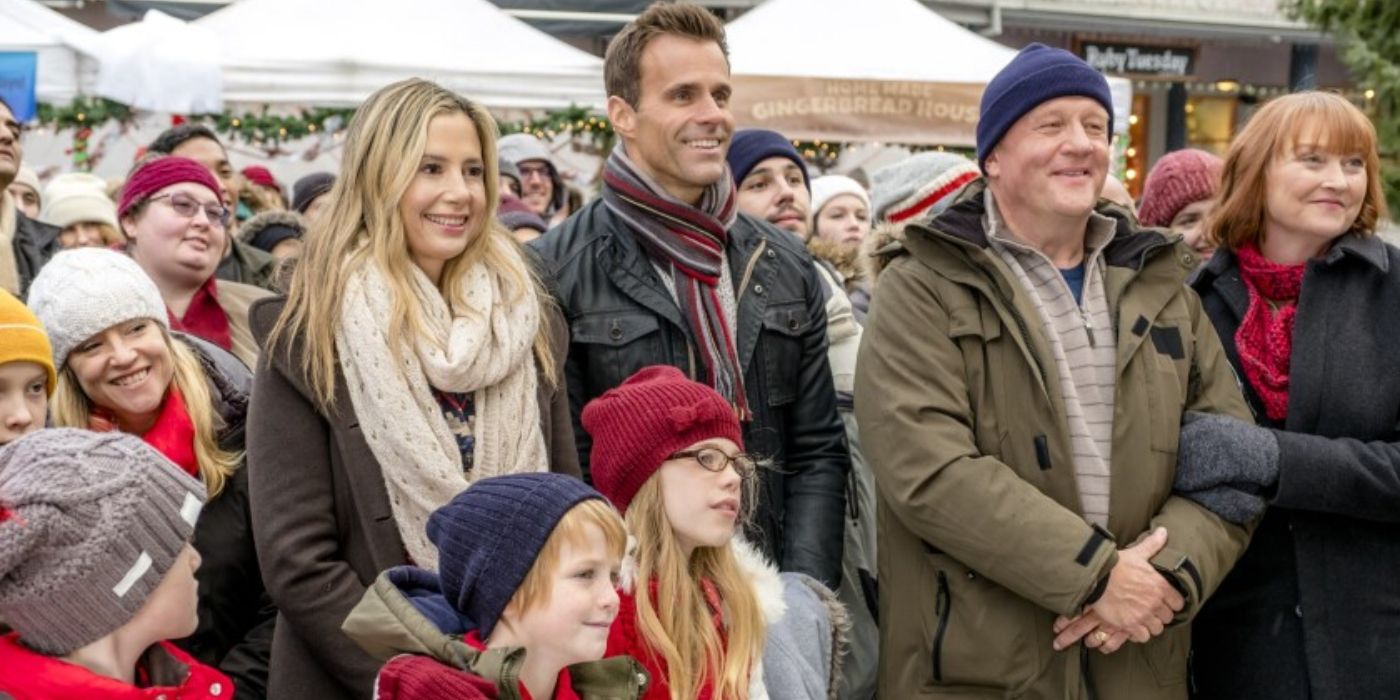 Jennifer and John with his family in A Christmas To Remember 
