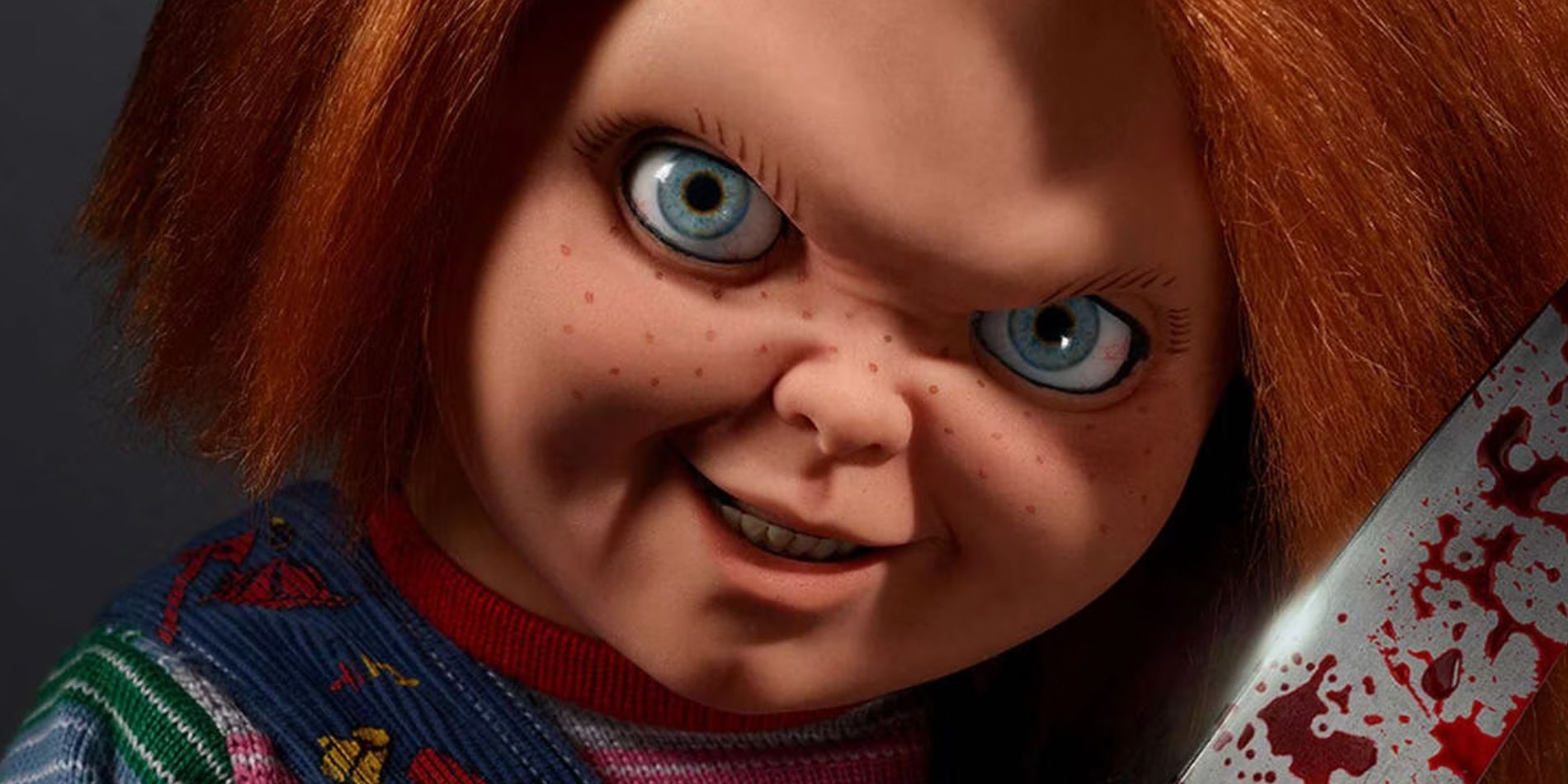 A closeup of Chucky with a bloody blade in a promotional image for the Chucky television series