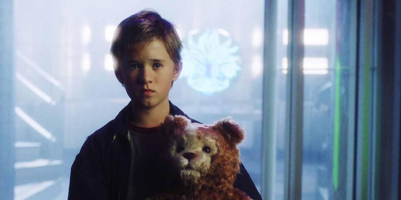 A.I. artificial intelligence David looking sad and holding a teddy bear